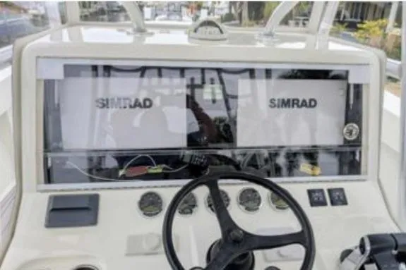 Slide: The Image of 2017 SeaVee 390Z boat dashboard with dual Simrad displays and steering wheel. - 5