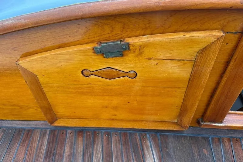 Slide: The Image of Vintage 1965 wooden boat hatch with intricate design and metal hinge. - 12