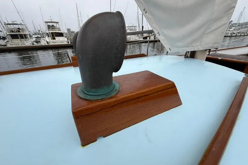 Slide: The Image of Vintage 1965 boat deck with wooden vent, marina background, overcast sky. - 15