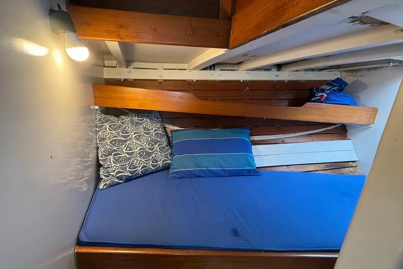 Slide: The Image of Cozy vintage 1965 boat cabin with blue bedding and wooden accents. - 24