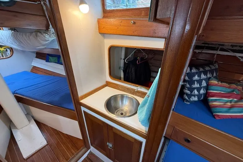 Slide: The Image of Vintage 1965 boat interior with wooden cabinetry, sink, and cozy sleeping area. - 26