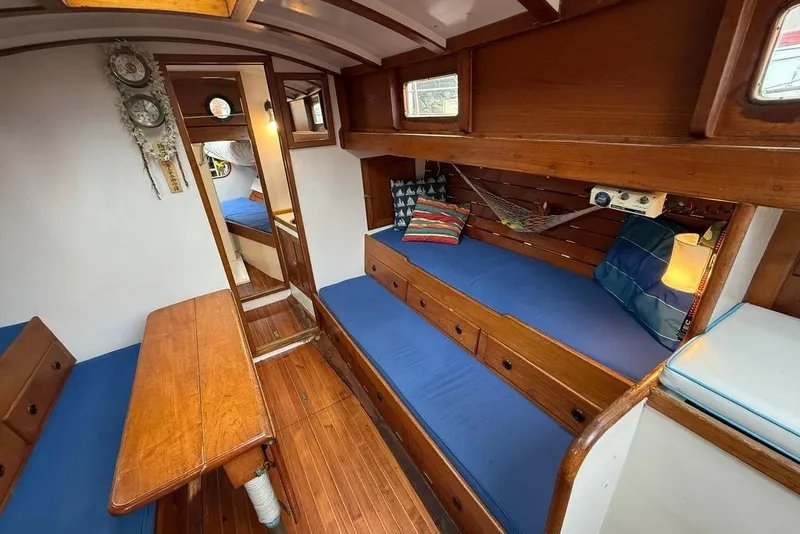 Slide: The Image of Vintage 1965 boat interior with wooden furnishings and blue cushions, featuring cozy seating and decor. - 29