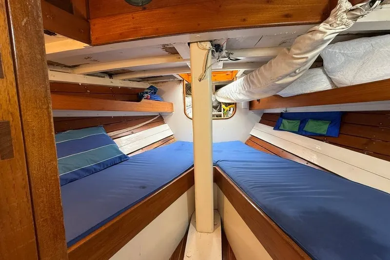 Slide: The Image of Vintage 1965 boat interior with wooden bunks and blue cushions. - 31