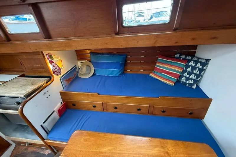 Slide: The Image of Cozy vintage boat interior with blue cushions, colorful pillows, and wooden accents, model 34, 1965. - 32
