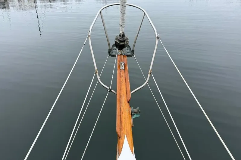 Slide: The Image of Bow of a 1965 Vintage 34 sailboat on calm water. - 7