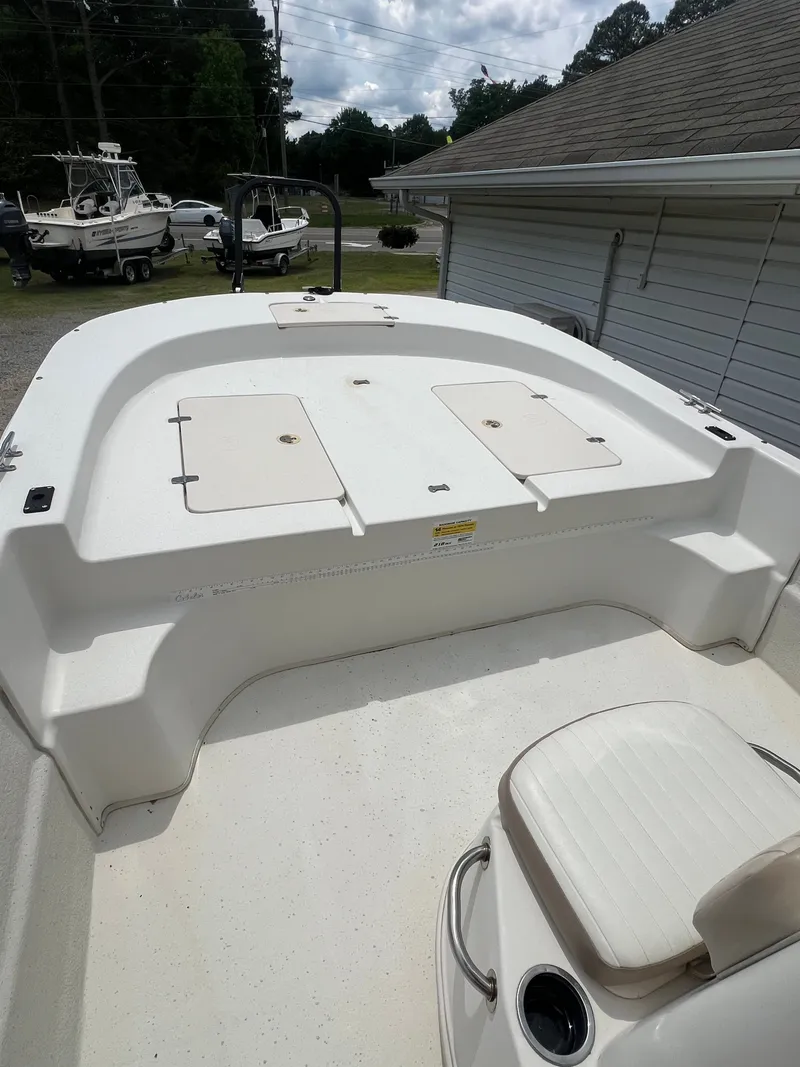 Slide: The Image of 2015 Carolina Skiff 218 DLV boat deck with storage and seating. - 14