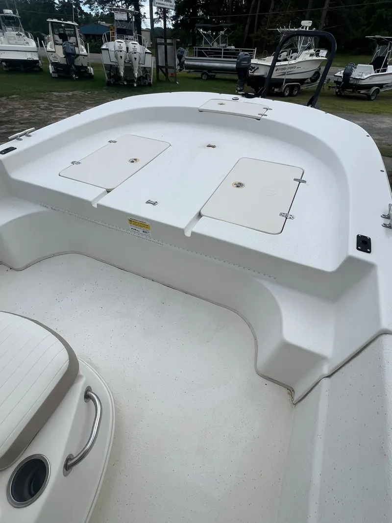 Slide: The Image of 2015 Carolina Skiff 218 DLV boat with storage hatches. - 15
