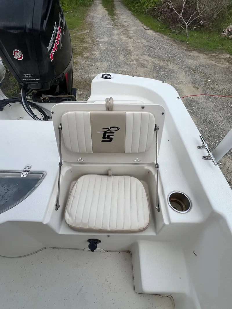 Slide: The Image of 2015 Carolina Skiff 218 DLV boat seat with motor in background. - 9