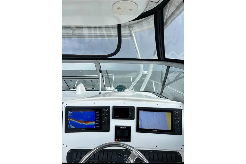Slide: The Image of Helm console of a 2004 Boston Whaler 305 Conquest boat. - 16