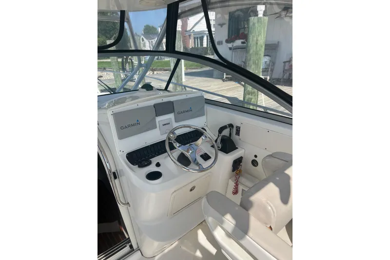 Slide: The Image of 2004 Boston Whaler 305 Conquest helm with Garmin navigation system and steering wheel. - 17