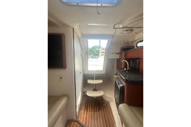 Slide: The Image of Interior of 2004 Boston Whaler 305 Conquest boat with kitchenette and seating area. - 23