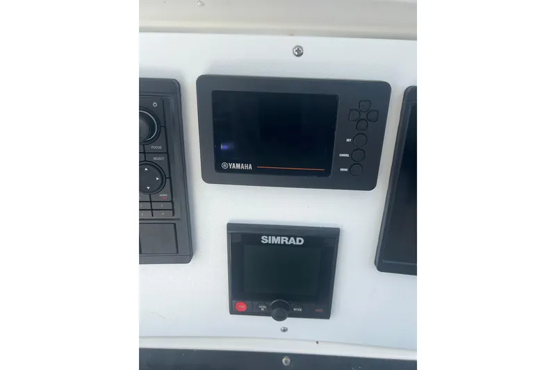 Slide: The Image of Control panel of a 2004 Boston Whaler 305 Conquest with Yamaha and Simrad displays. - 25