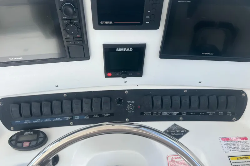 Slide: The Image of Control panel of a 2004 Boston Whaler 305 Conquest with Garmin and Simrad displays. - 26
