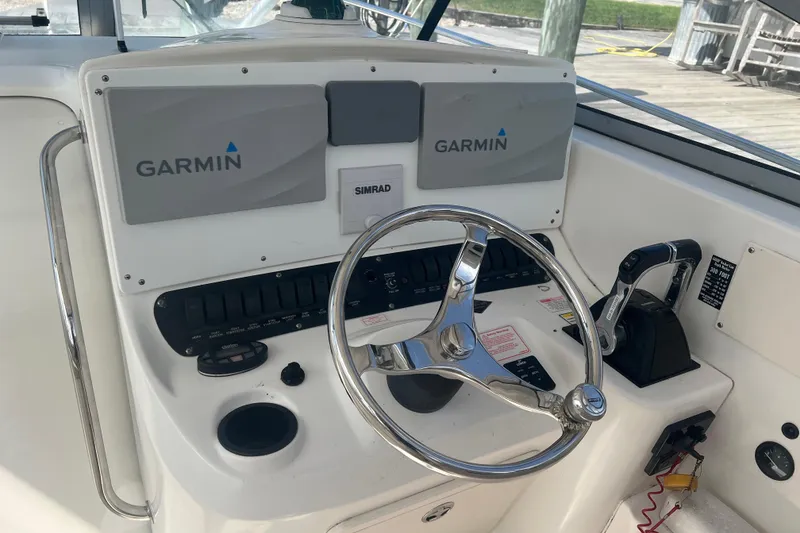 Slide: The Image of 2004 Boston Whaler 305 Conquest helm with Garmin and Simrad electronics. - 5