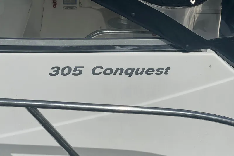 Slide: The Image of 2004 Boston Whaler 305 Conquest boat nameplate detail. - 7