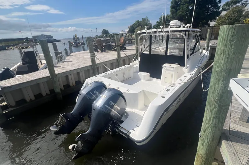 Slide: The Image of 2004 Boston Whaler 305 Conquest docked with twin Yamaha outboard engines. - 8