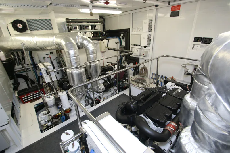 Slide: The Image of Engine room of 2015 Hargrave 76 yacht, featuring advanced machinery and piping systems. - 15