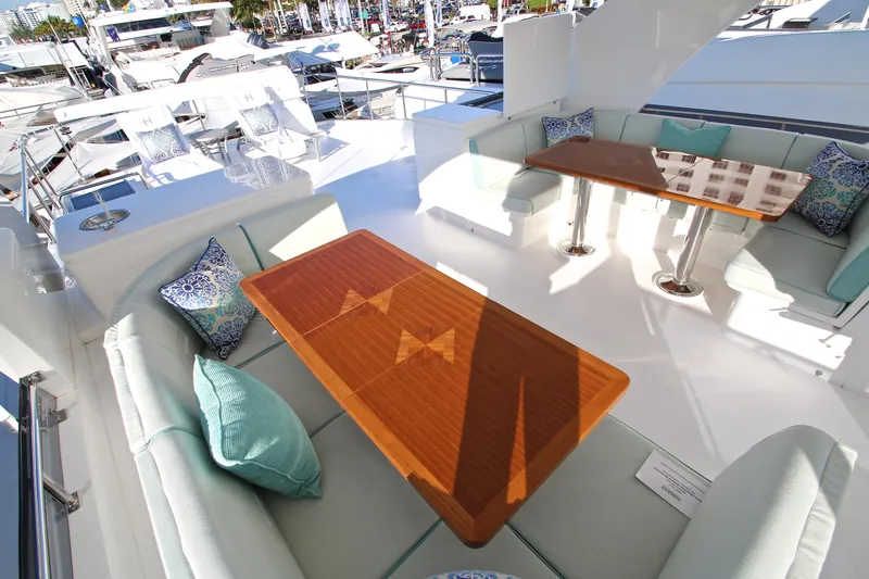 Slide: The Image of Luxurious 2015 Hargrave 76 yacht deck with elegant seating and wooden tables. - 17