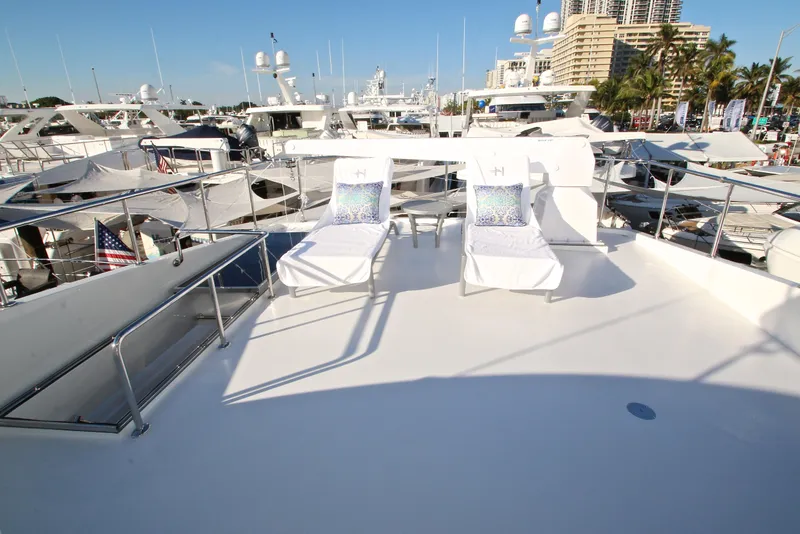 Slide: The Image of Luxurious 2015 Hargrave 76 yacht deck with sun loungers, surrounded by other yachts. - 18