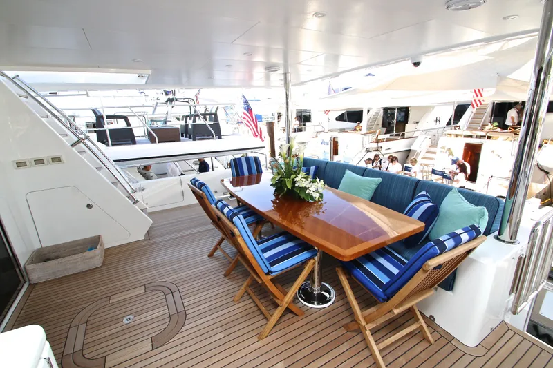 Slide: The Image of Luxurious 2015 Hargrave 76 yacht deck with elegant dining area and striped cushions. - 23
