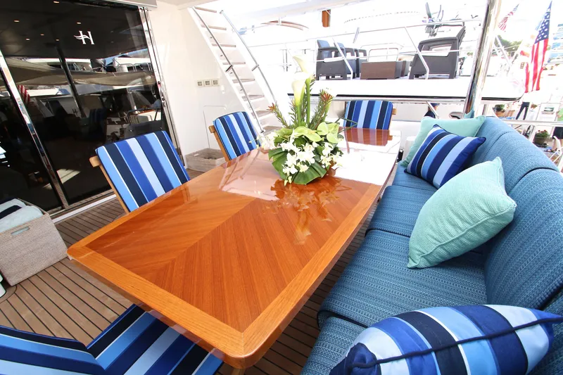 Slide: The Image of Luxurious 2015 Hargrave 76 yacht deck with elegant dining area and striped cushions. - 24