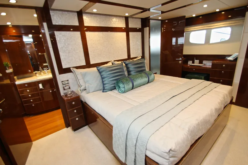 Slide: The Image of Luxurious bedroom interior on 2015 Hargrave 76 yacht, featuring elegant wood finishes and plush bedding. - 51