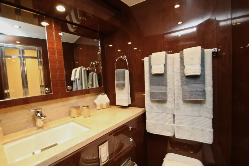 Slide: The Image of Luxurious bathroom in 2015 Hargrave 76 yacht with elegant wood paneling and plush towels. - 61