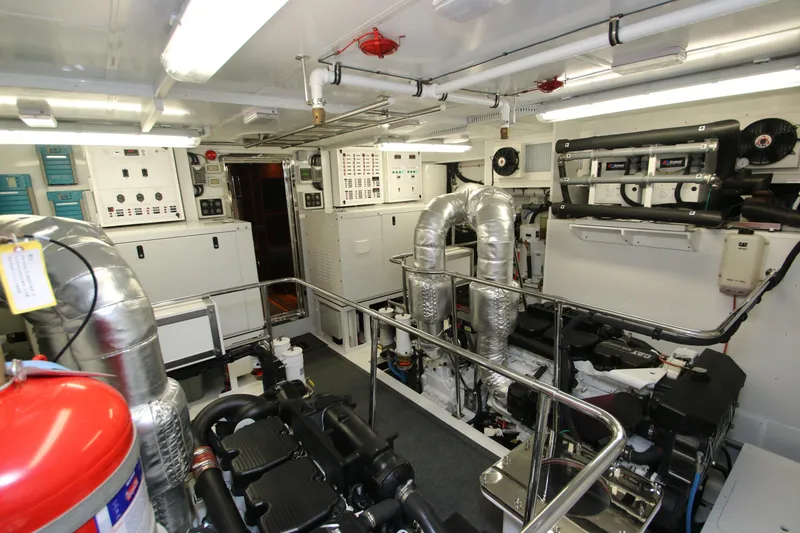Slide: The Image of Engine room of 2015 Hargrave 76 yacht, featuring advanced machinery and control panels. - 9