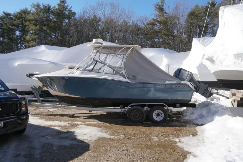 The Image of 2011 Grady-White Freedom 255 boat on trailer in snowy outdoor setting. - 0