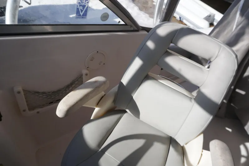 Slide: The Image of Captain's chair on 2011 Grady-White Freedom 255 boat, featuring comfortable design and armrests. - 12