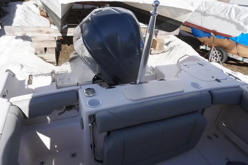 Slide: The Image of 2011 Grady-White Freedom 255 boat with outboard motor, docked in snowy surroundings. - 15