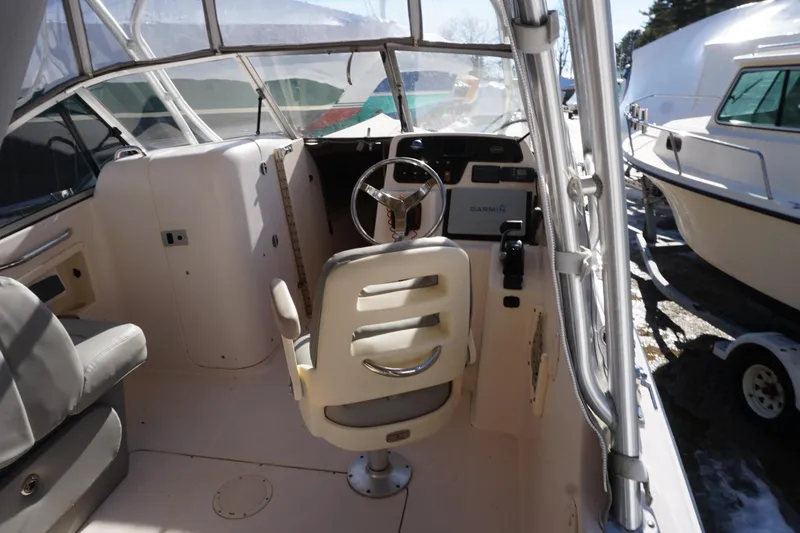 Slide: The Image of 2011 Grady-White Freedom 255 boat interior with steering wheel and seating. - 17
