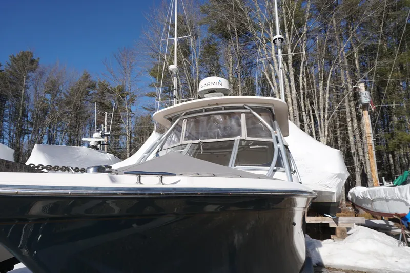 Slide: The Image of 2011 Grady-White Freedom 255 boat in winter storage, surrounded by trees. - 21