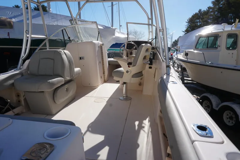 Slide: The Image of 2011 Grady-White Freedom 255 boat interior with seating and steering console. - 4
