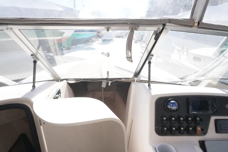 Slide: The Image of 2011 Grady-White Freedom 255 boat interior with dashboard and windshield view. - 8