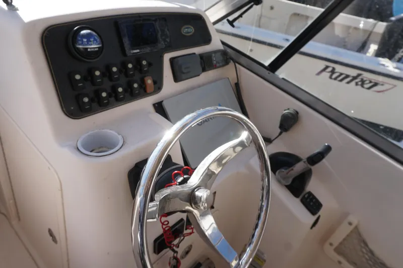 Slide: The Image of 2011 Grady-White Freedom 255 boat dashboard with steering wheel and control panel. - 9