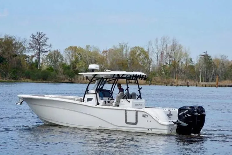 The Image of 2023 Sea Fox 328 Commander boat cruising on a calm river with trees in the background. - 0