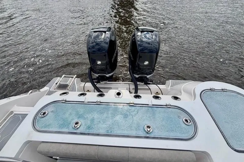 Slide: The Image of 2023 Sea Fox 328 Commander boat with dual outboard engines on water. - 10