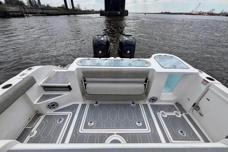 Slide: The Image of 2023 Sea Fox 328 Commander boat interior with dual engines on a calm river. - 9