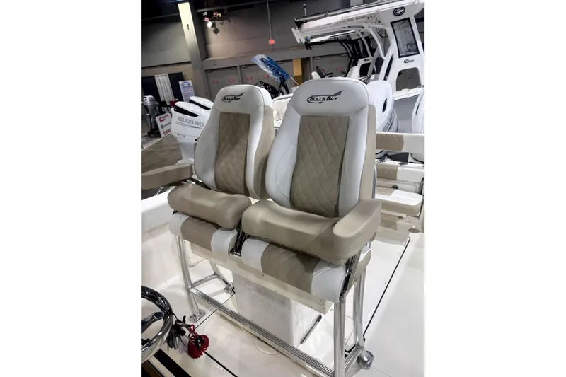 Slide: The Image of 2024 Bulls Bay 255 Center Console boat seats with beige and white upholstery. - 4
