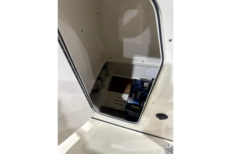 Slide: The Image of 2024 Bulls Bay 255 Center Console storage compartment interior view. - 6