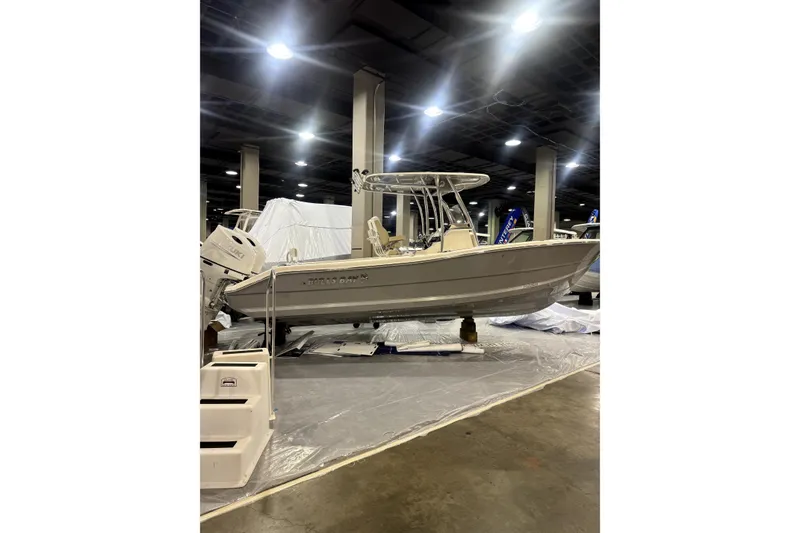 The Image of 2024 Bulls Bay 255 Center Console boat displayed indoors at a showroom. - 1