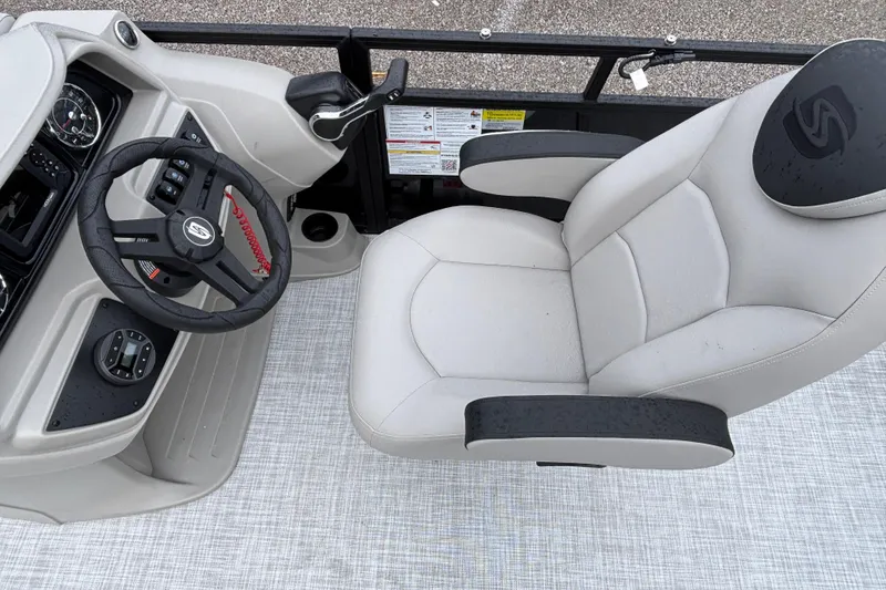 Slide: The Image of Captain's chair and helm of 2026 Dockside 20DF boat, featuring modern controls and steering. - 10