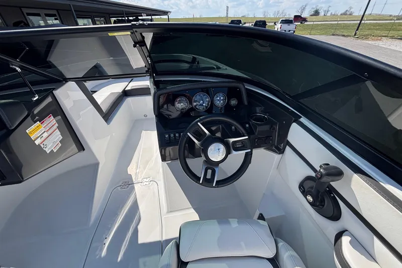 Slide: The Image of 2021 Monterey M-22 boat cockpit with steering wheel and dashboard controls. - 9