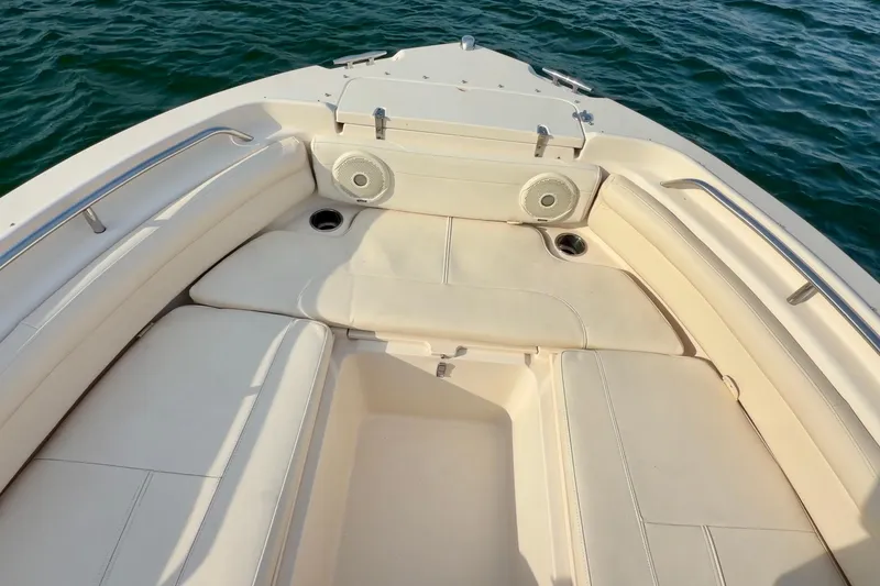 Slide: The Image of 2017 Grady-White Freedom 225 boat interior with cushioned seating and ocean view. - 10