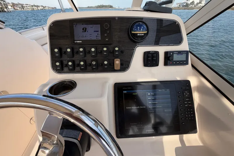 Slide: The Image of 2017 Grady-White Freedom 225 boat dashboard with navigation and control systems. - 16