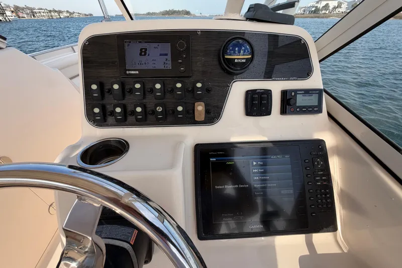 Slide: The Image of Control panel of 2017 Grady-White Freedom 225 boat with navigation and audio systems. - 17
