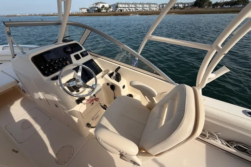 Slide: The Image of 2017 Grady-White Freedom 225 boat interior with steering wheel and control panel. - 21