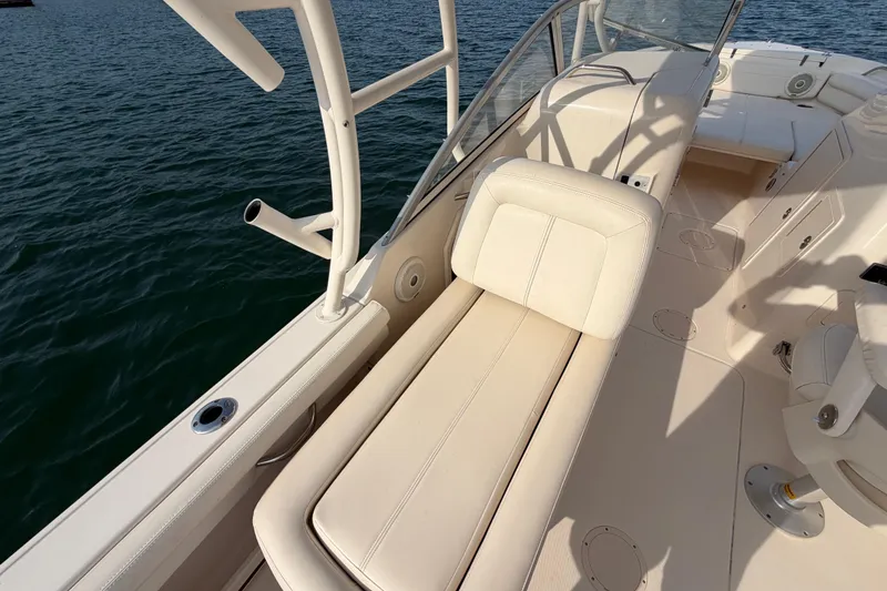 Slide: The Image of 2017 Grady-White Freedom 225 boat interior with seating, on calm water. - 23