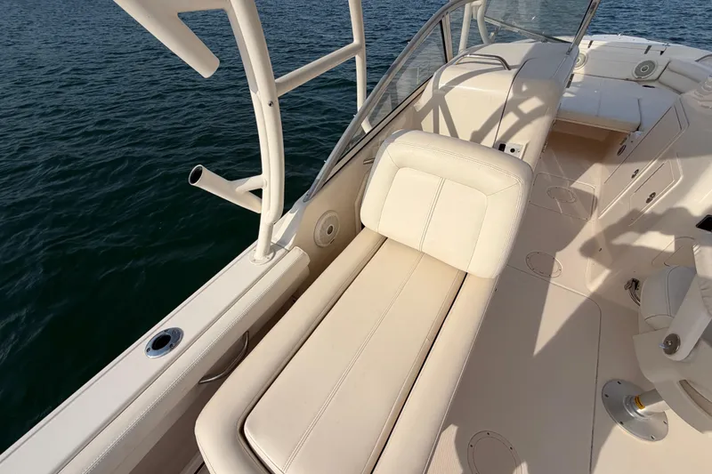 Slide: The Image of 2017 Grady-White Freedom 225 boat interior with seating, on calm water. - 24